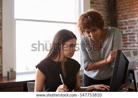 Two Businesswomen Working On Computer In Office Royalty-Free Stock Photo #547753810