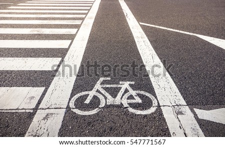 Bike lane symbol with crosswalk on asphalt street