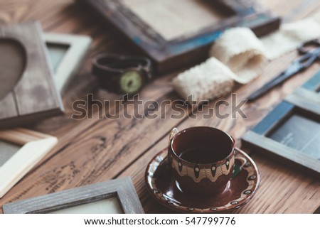 Many wooden photo frames on the rustic table, top view