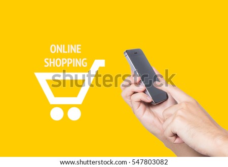 Close up hand holding phone with cart icon against yellow background, E-commerce and online shopping concept