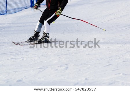 Man skier riding down the slope at the mountains