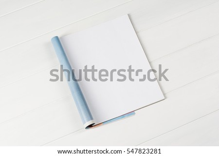 Mock-up magazine or catalog on wooden table. Blank page or notepad on wood background. Blank page or notepad for mockups or simulations. Royalty-Free Stock Photo #547823281