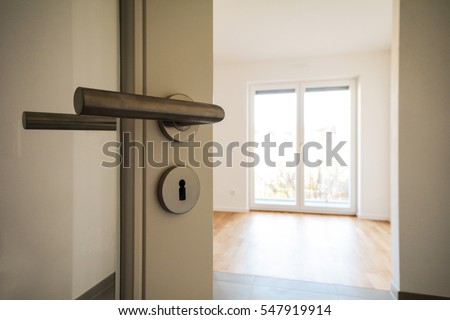 New construction property - Relocation Moving to new apartment - Door to modern living room Royalty-Free Stock Photo #547919914