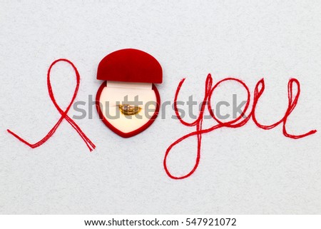 Love you words and heart symbol made of red thread on a white background for your Valentine's day