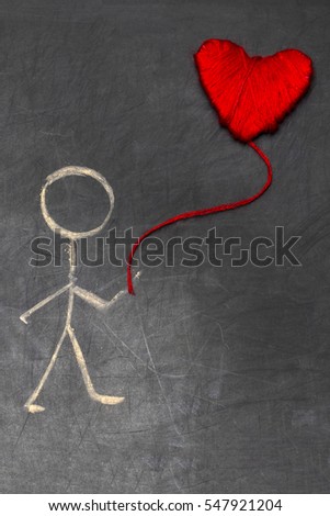 cartoon man with chalk on blackboard with red heart in a balloon