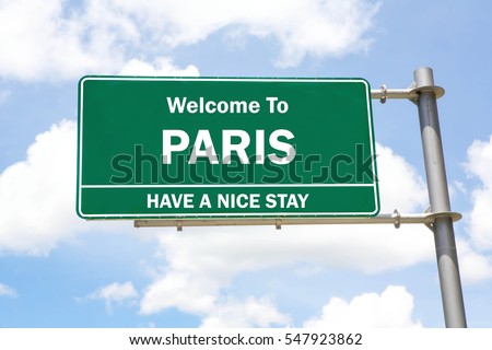 Green overhead road sign with a Welcome to Paris, Have a Nice Stay concept against a partly cloudy sky background.
