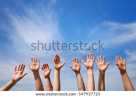 volunteering concept, hands of group of people volunteers in blue sky Royalty-Free Stock Photo #547937725