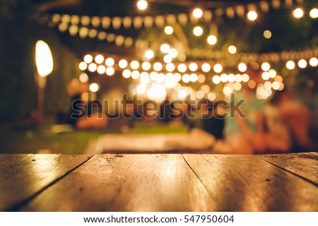 Image of wooden table in front of abstract blurred restaurant lights background Royalty-Free Stock Photo #547950604