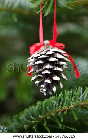 Christmas decoration ornament on green xmas pine tree. Blurry background with bokeh.