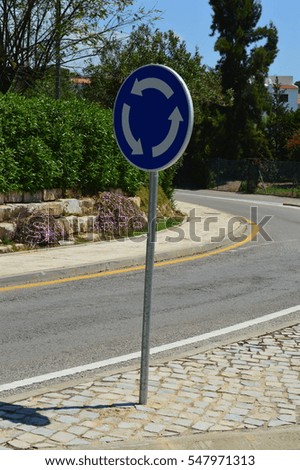 Roundabout Symbol in the Park with Trees and Sidewalk