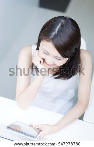 Young Asian woman using digital tablet