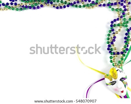 Mardi Gras decor on a white surface with copy space