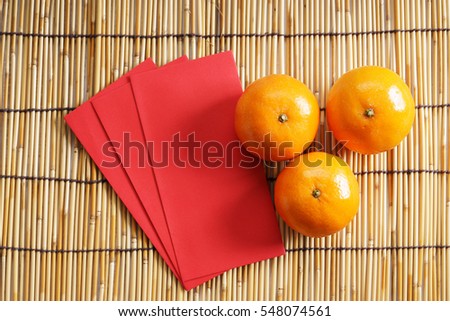 Chinese new year festival decorations, ang pow or red packets and mandarin oranges