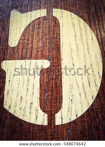 Wooden alphabet letter G, mirrored back. Written letter with paint on a wooden background. Alphabet wood texture.