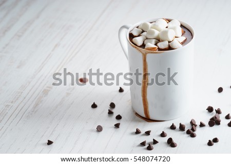 hot chocolate in white cup with marshmallows and chocolate chip