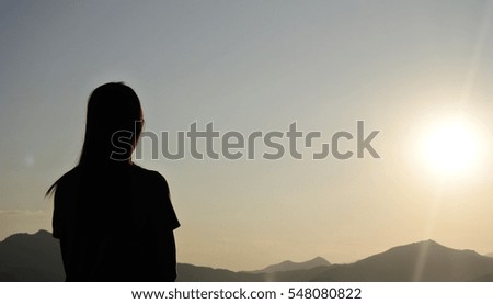 Silhouette of woman who is looking sun for set her goal by intention