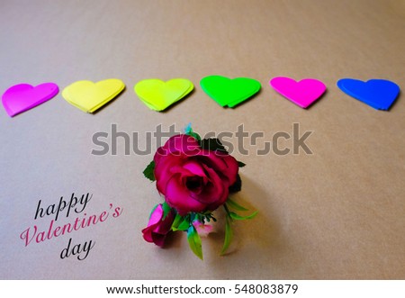 Colorful hearts shape over wood background with Happy Valentine's Day word