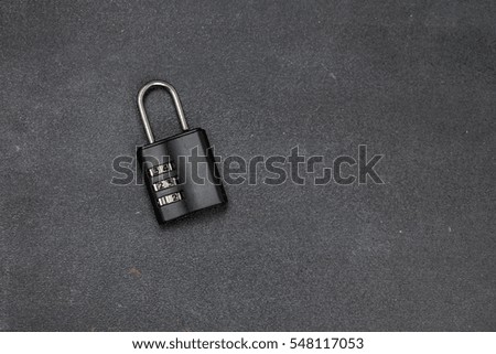 Combination lock on the brown wooden table background
