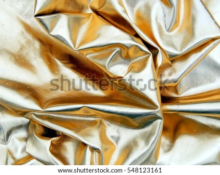 Gold satin fabric close up