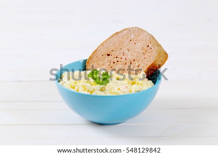 meat loaf with potato salad in turquoise bowl