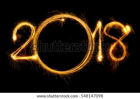Happy new year 2018 text written with Sparkle fireworks isolated on black background Royalty-Free Stock Photo #548147098