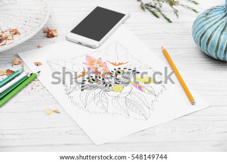 Coloring anti stress picture on white wooden table, closeup