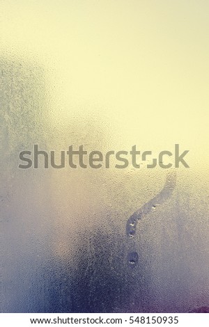 Blurry question mark on foggy condensation window glass natural surface background