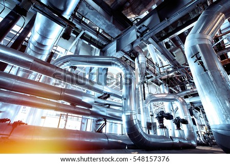 Equipment, cables and piping as found inside of  industrial power plant Royalty-Free Stock Photo #548157376