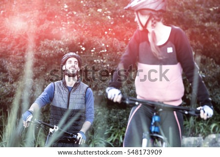 Smiling biker couple cycling in countryside