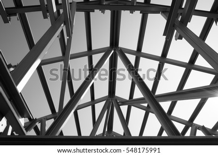 Black and white photo,Structure of steel roof frame for building construction.