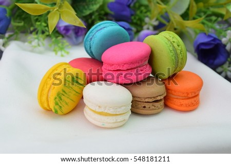 Dessert Macaroon candy comes in many colors to put on white fabric with purple flowers.
