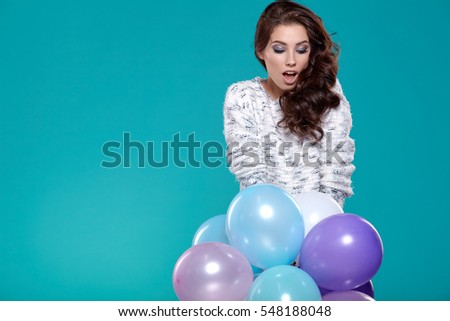 Young pretty woman with colored balloons