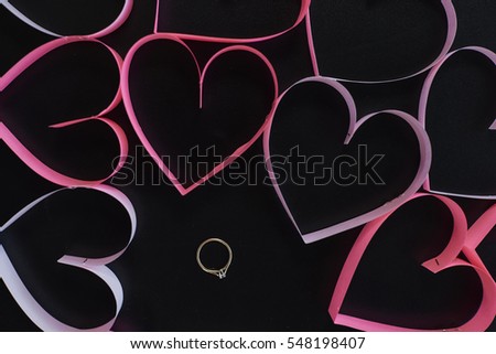 Gold ring among pink hearts