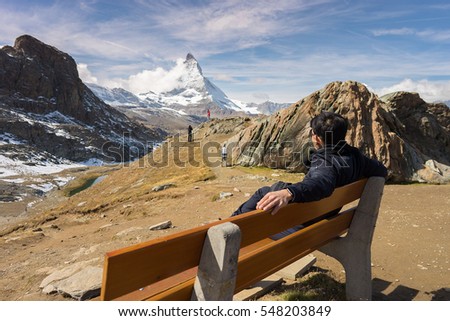 This is a picture of myself sitting on the chair looking at MATTERHORN mountain at RIFFELSEE , ZERMATT , SWITZERLAND.