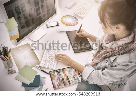 High angle view of an artist drawing something on graphic tablet at the office