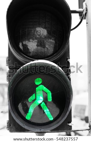 Traffic light with green signal in the street