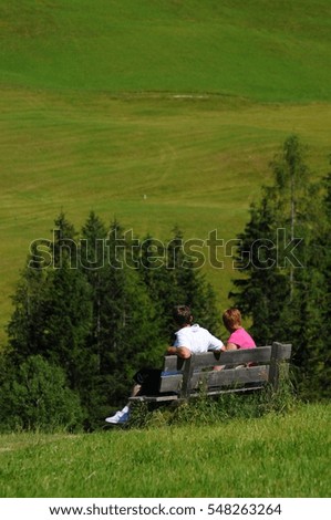 a couple admires the view in relaxation of the Dolomites in Alta Badia, Italy