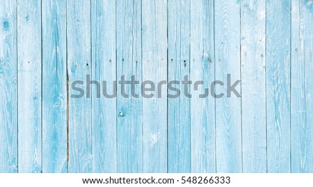 Natural Rustic Old Wood Board Wall Faded Blue Color Background. Wooden Vintage Style Texture. Wood Surface Fence Panel with Peeling Paint Close up. Wide Horizontal Image Copy Space.