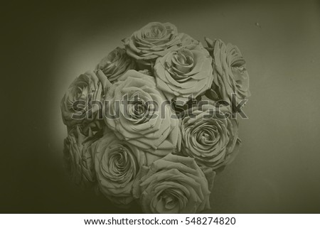 Arrangement of blooming roses. Romantic bouquet with withering flowers for birthday gift, mothers day, valentines love present, wedding bridal decoration. Image with monochrome vintage filter effect.