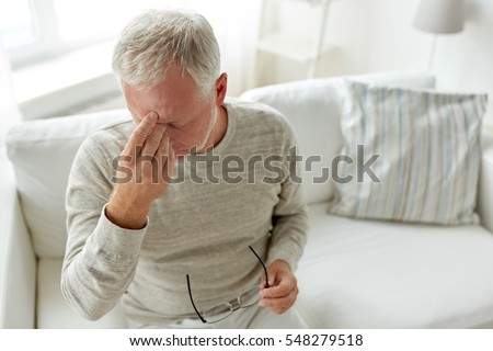 healthcare, pain, stress, age and people concept - senior man suffering from headache at home Royalty-Free Stock Photo #548279518