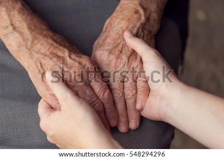 Old and young person holding hands. Elderly care and respect, selective focus Royalty-Free Stock Photo #548294296