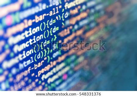 Writing programming functions on laptop. Website HTML Code on the Laptop Display Closeup Photo. Database bits access stream visualisation. 
