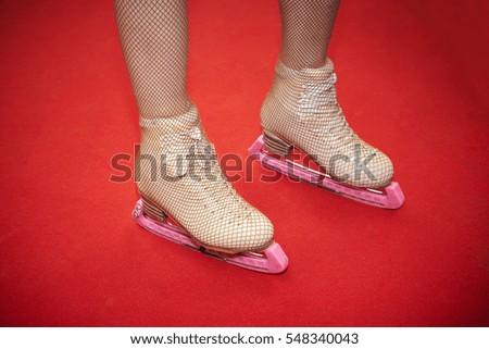ice skates isolated on red carpet.