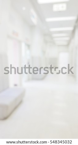 Blur abstract background perspective view of waiting zone seat row in hospital building interior. Blurry area child patients waiting to see doctors, pediatric ward.Defocus corridor in clean clinic.