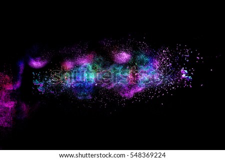 Freeze motion of colored dust explosion isolated on black background.