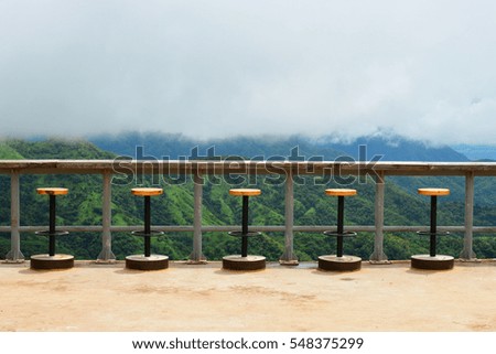 Beautiful wooden stools with fog view of mountain.