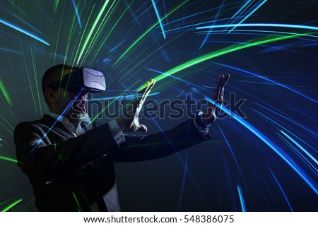 amazed young businessman using a VR headset and experiencing virtual reality