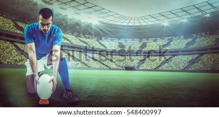 Full length of rugby player placing ball against rugby stadium with copy space 3d