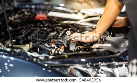 Hand of auto mechanic with a wrench. Car repair Royalty-Free Stock Photo #548405956