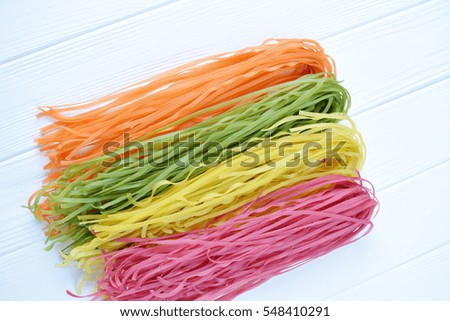  Multicolored pasta uncooked on a white background